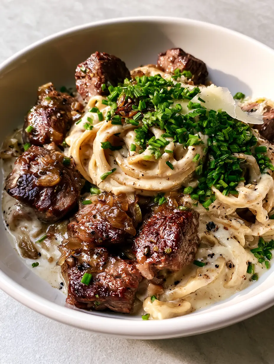 Simple and tasty recipe for Creamy Garlic Butter Steak Fettuccine 3 Extreme close-up of deeply seared steak bites with a glossy garlic butter glaze. (Simple and tasty recipe)