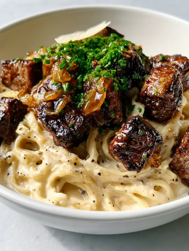 Simple and tasty recipe for Creamy Garlic Butter Steak Fettuccine 1 Silky ivory cream sauce over fettuccine with cracked black pepper flecks.