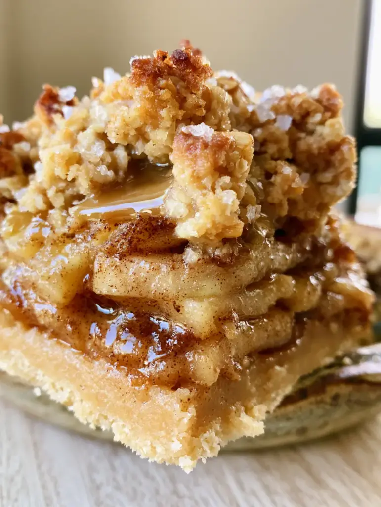Close-up of Apple Bars showing the dense stack of thinly sliced Granny Smith apples and the dark cinnamon glaze.