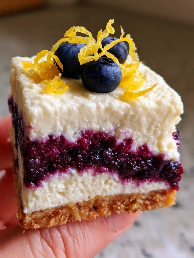 Close-up of the toasted almond flour crust and blueberry garnish on the Blueberry and Lemon Zest Cottage Cheese Bites.